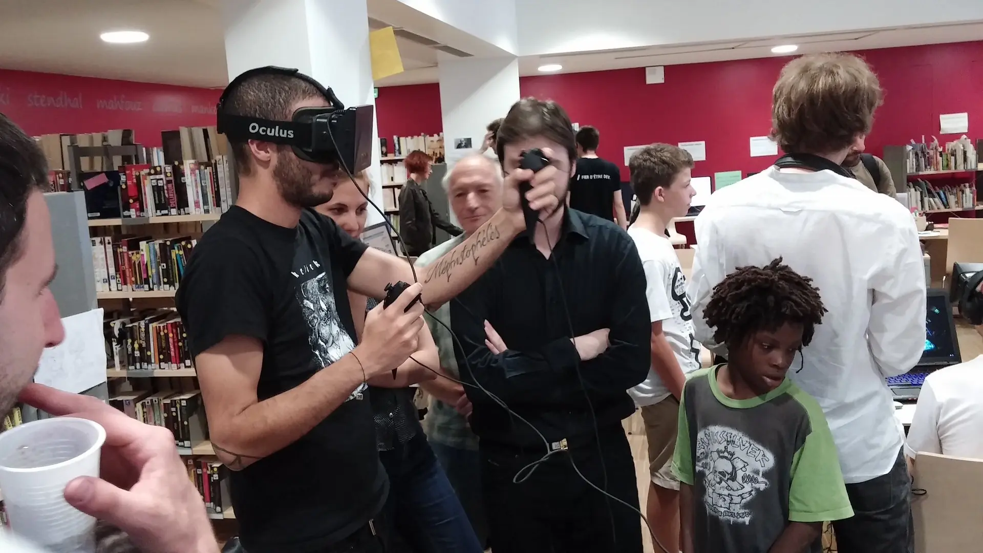 People use an Oculus VR headset at an event.