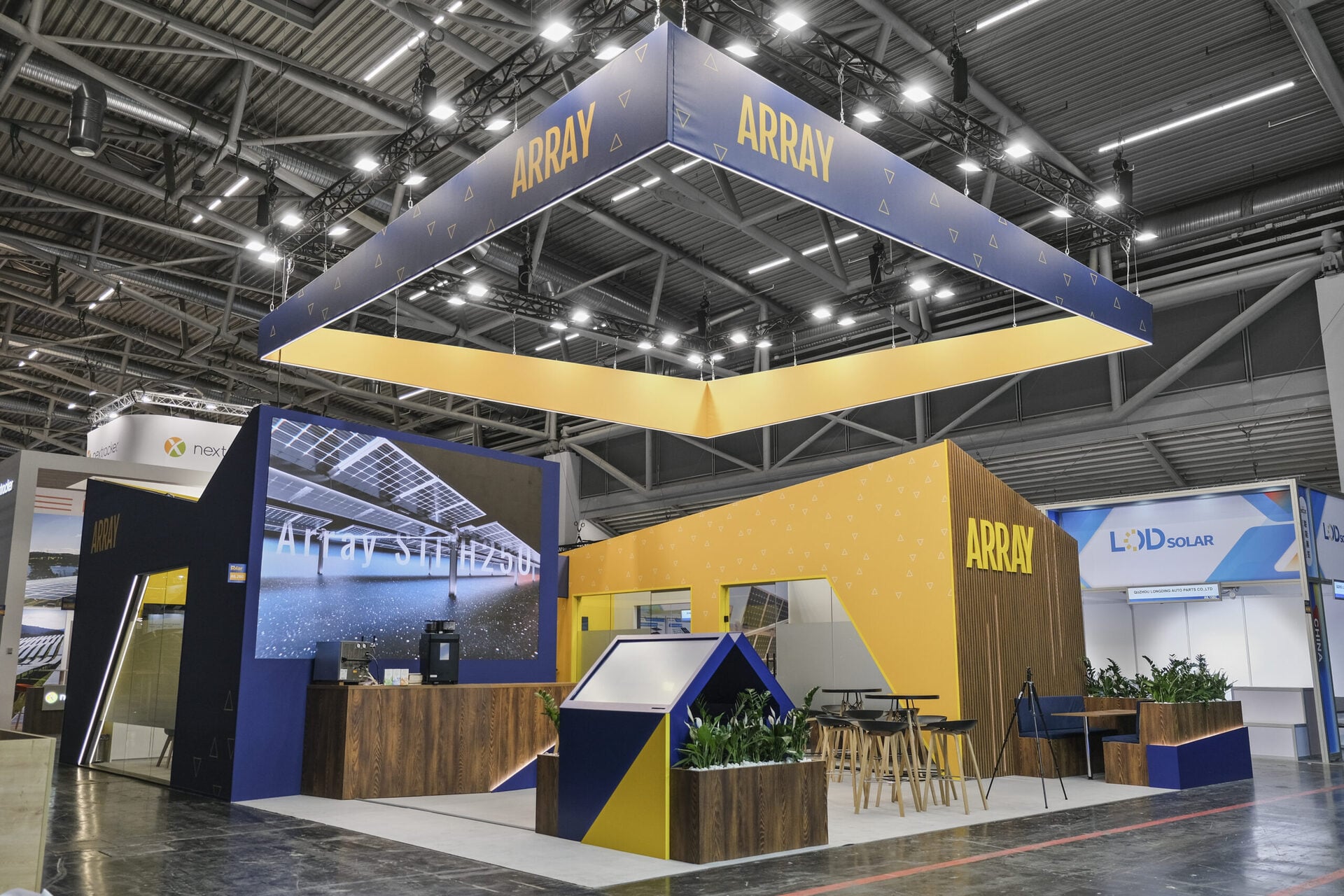 array-trade-show-booth-builder-uk-blue-gold-overhead-signage-scaled.jpg