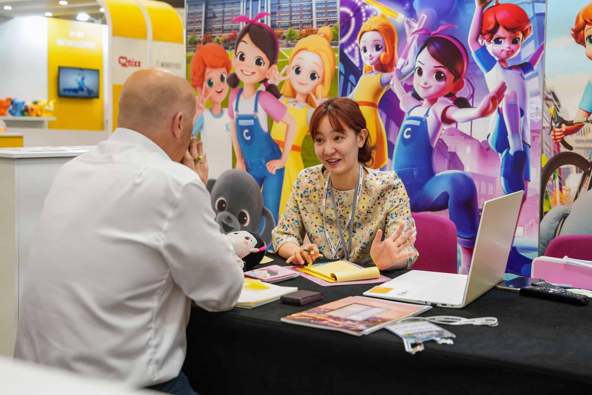 Exhibitor discussing a custom exhibition stand with a visitor at a UK exhibition