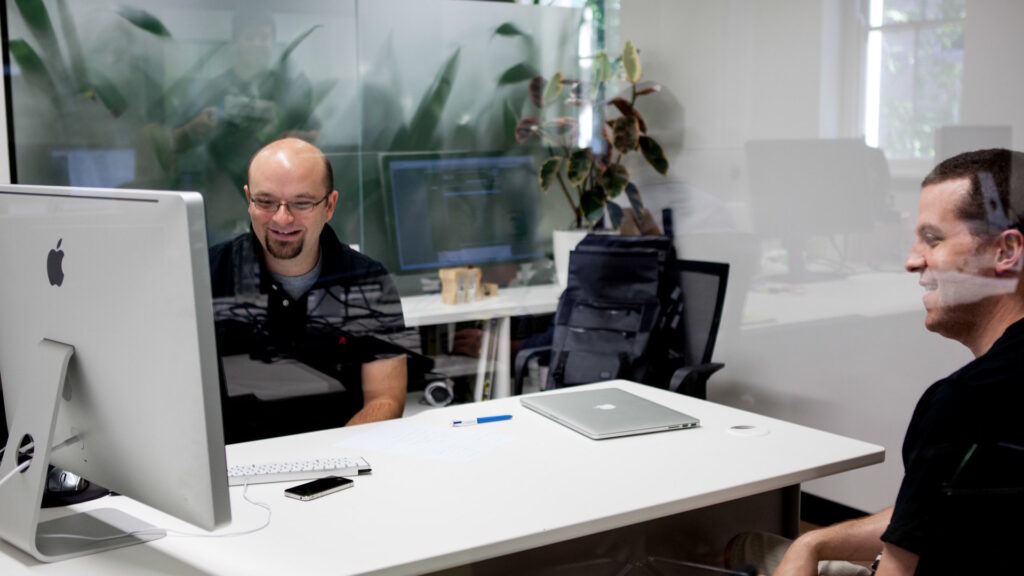 Two men collaborating in a modern office.
