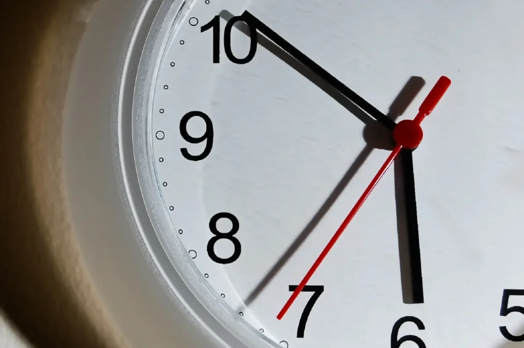 Closeup of a clock face showing the time as 5:50.