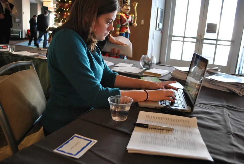 A woman working on a laptop.