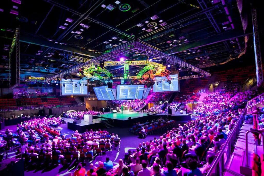 Durban ICC arena interior with packed audience and dramatic stage lighting at a major event