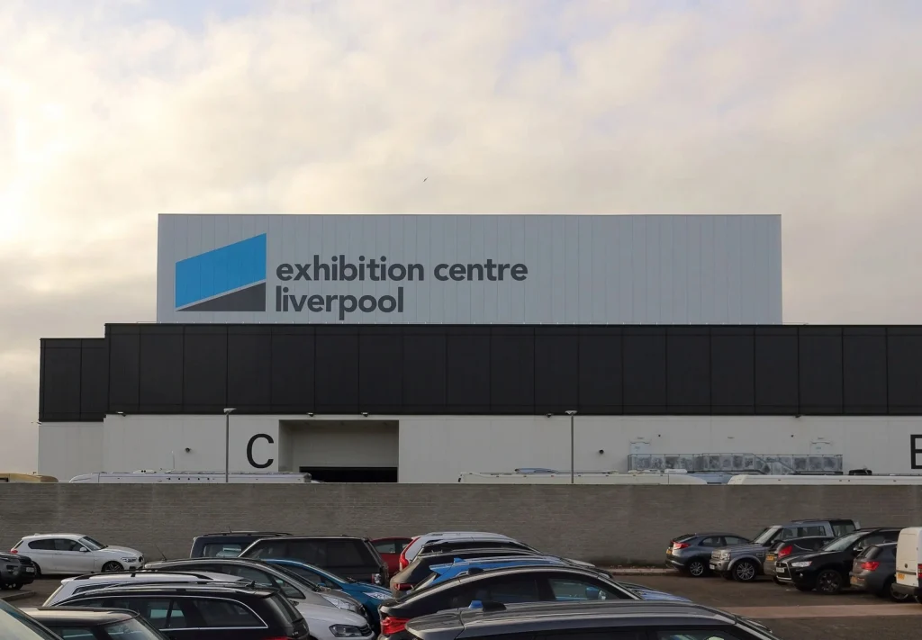 The side of the Exhibition Centre Liverpool showing the venue's logo.