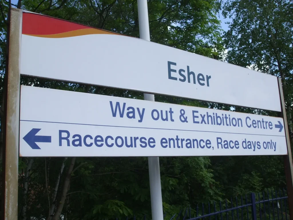 A directional sign in Esher showing the way to the Racecourse entrance and exhibition centre. 