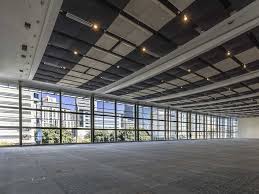 Empty CTICC exhibition hall interior showing concrete floor, truss ceiling and large windows