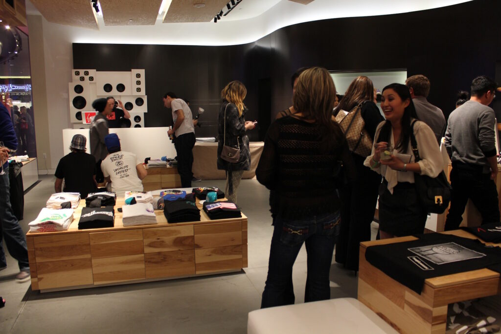 Multiple customers converse inside a fashion pop-up store. 