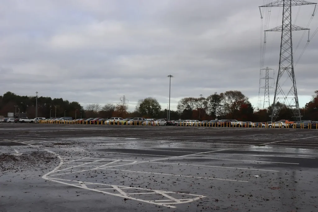 Large parking lot at the NEC after rain.