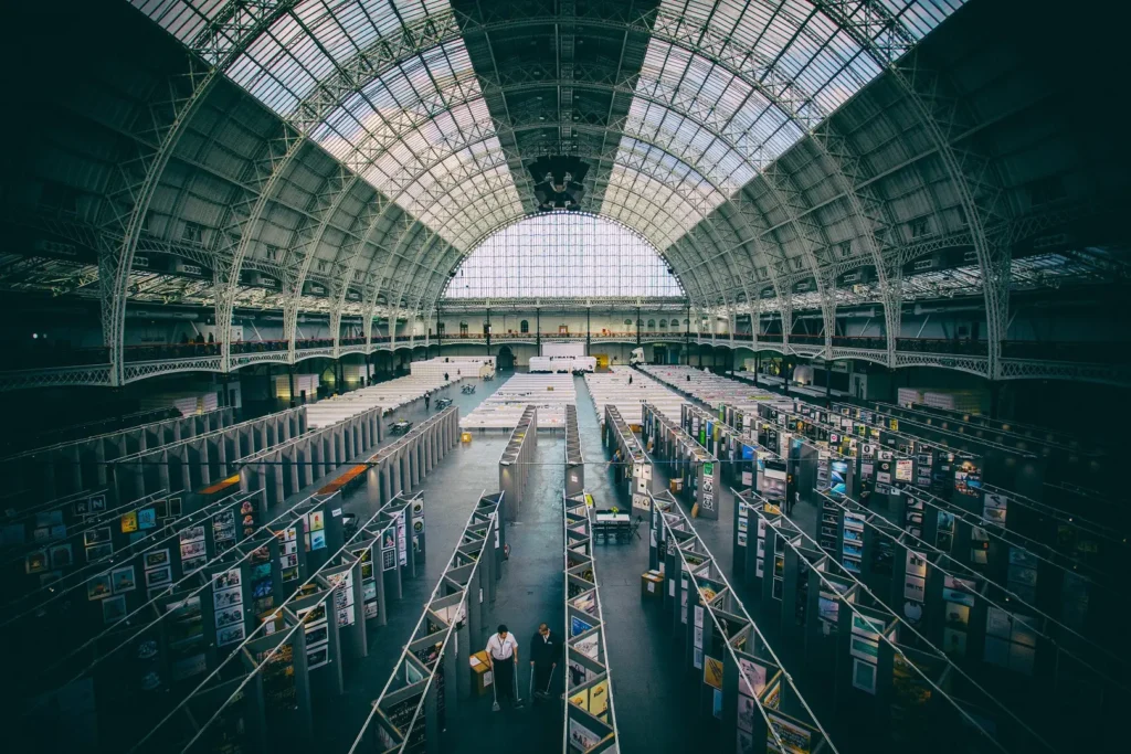 The interior of the London Olympia showing the exhibition floor and famous arched roof. 