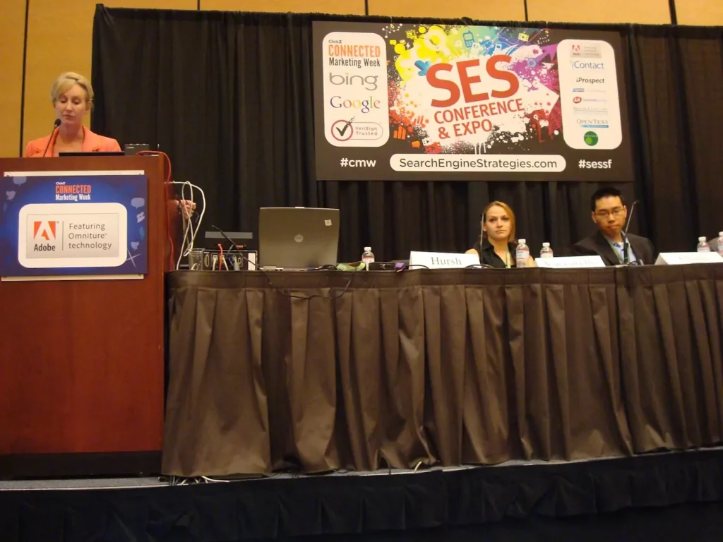 A speaker takes the podium at a panel discussion at the SES Conference & Expo in America. 