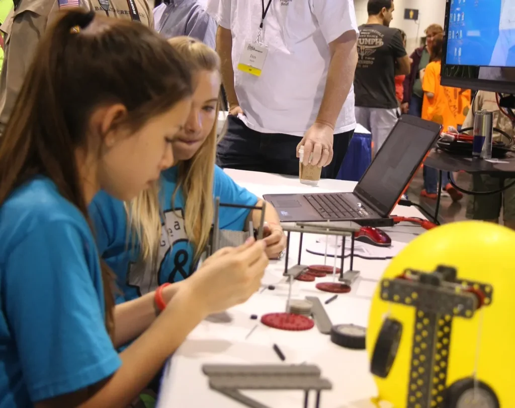 Exhibition staff interacting with products at an exhibition. 