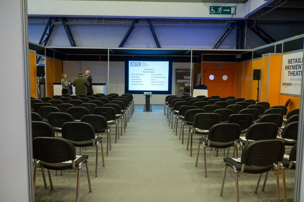 A smaller conference room with a projector screen in the centre. 