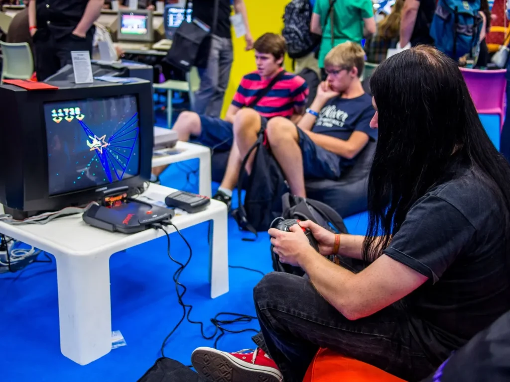 A person playing a retro video game on an old console. 