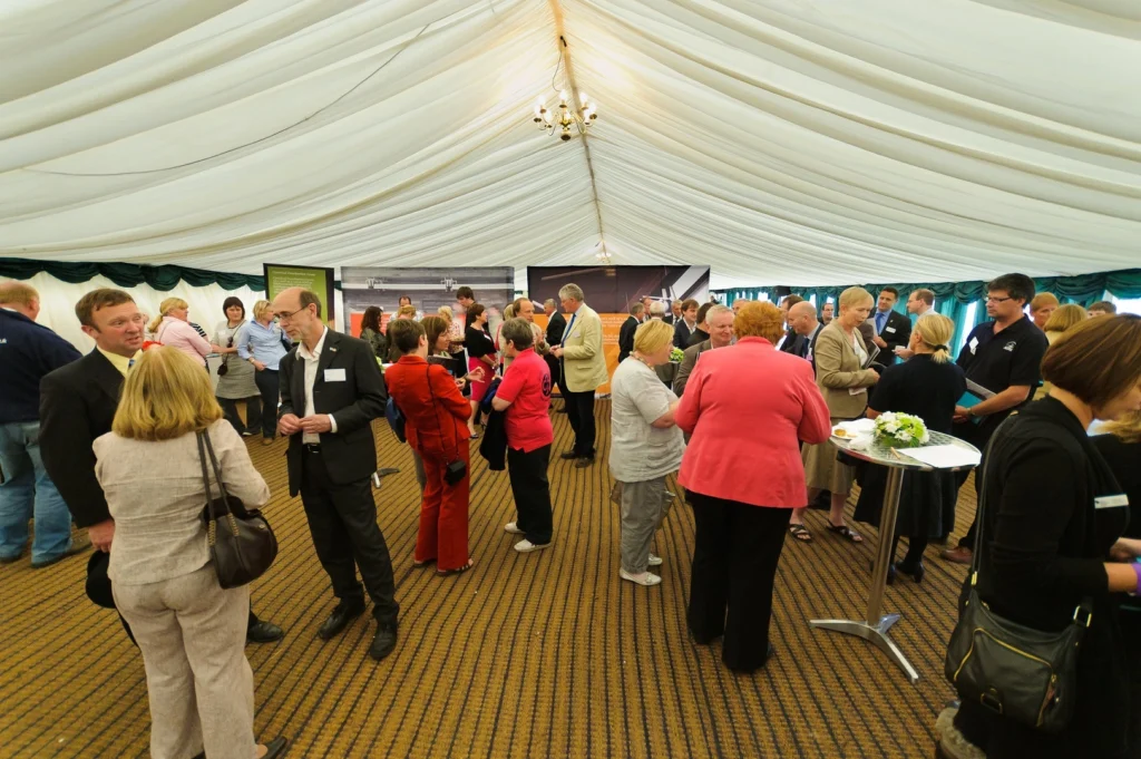 Multiple attendees congregated inside a tent for the Royal Welsh Show.