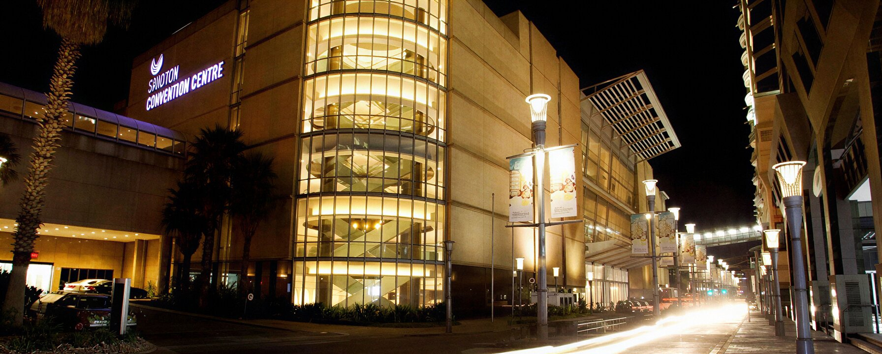 Sandton Convention Centre night exterior with illuminated curved glass facade