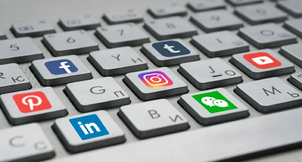 Computer keys with letters replaced by social media logos.