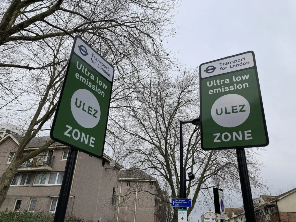 Two green ULEZ street signs.